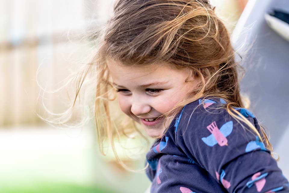 Young girl smiling at Onehunga childcare centre