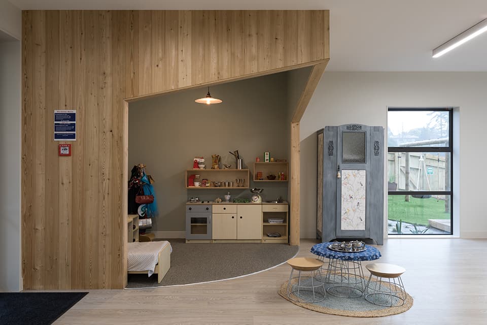Interior photo of the wooden house built in the over 2s area of purpose built childcare centre in Glen Eden