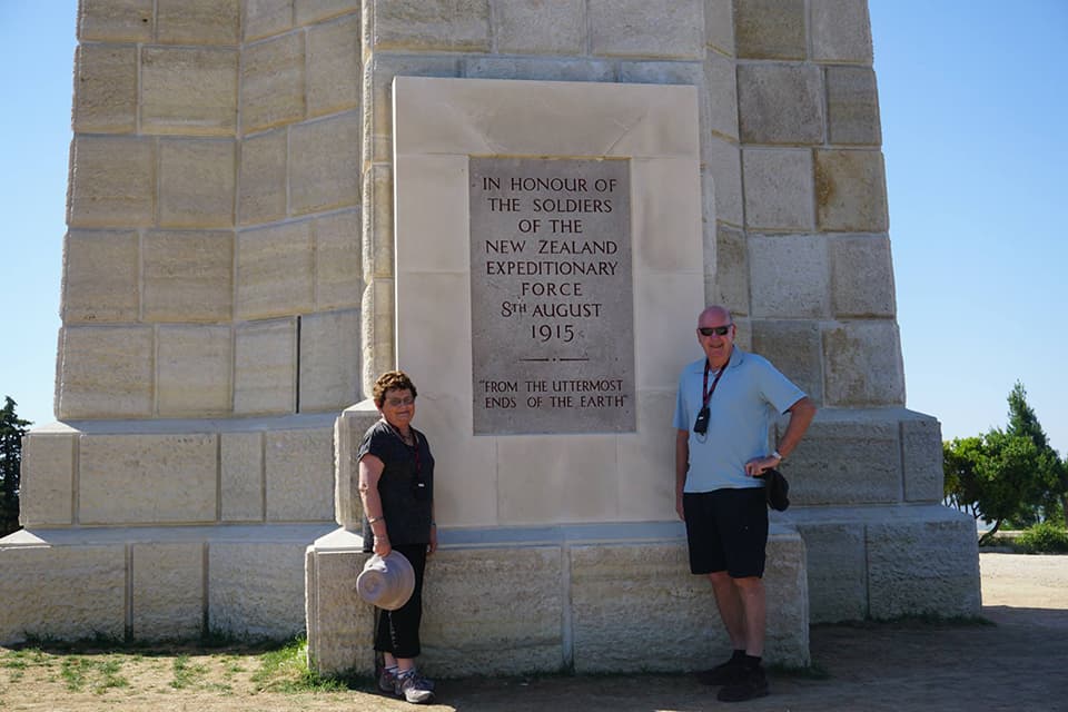 Two people standing by memorial of ANZAC Day at Gallipoli