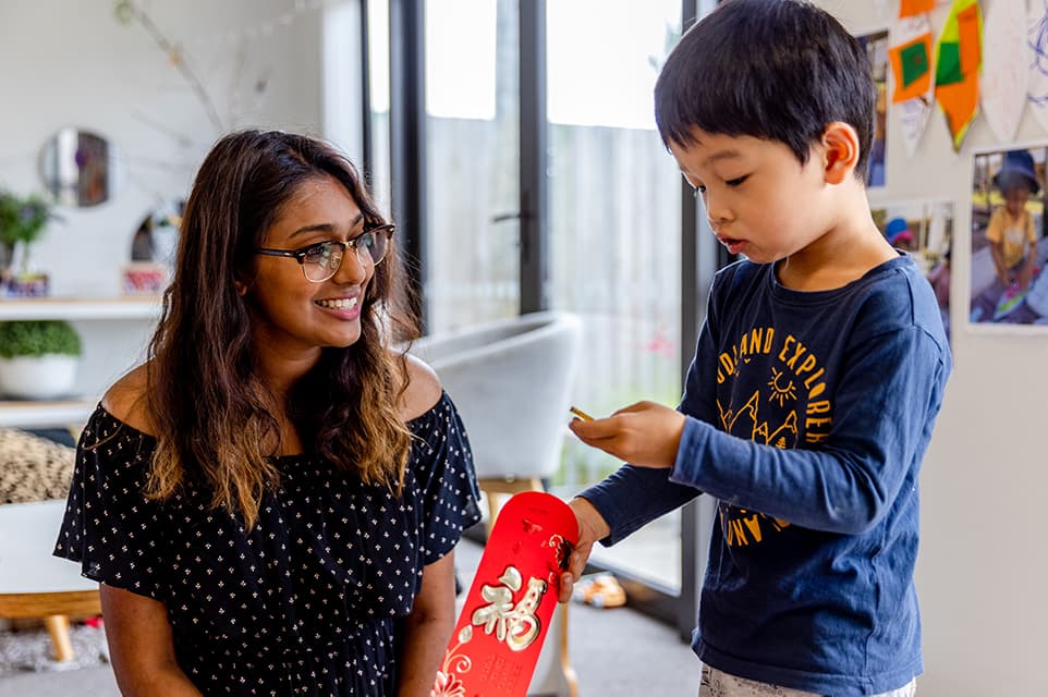 Young boy receiving a lucky red envelope for Chinese New Year